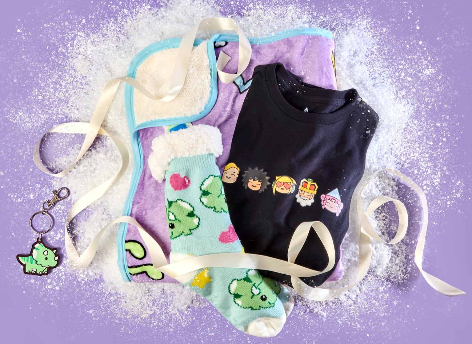 Cute MySims themed merchandise including socks, a blanket, key chain and t-shirt. Each item has designs of MySims characters on it.
